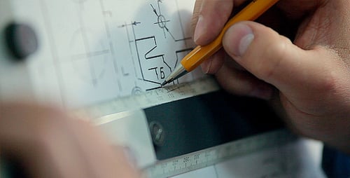 Man Draws a Technical Drawing on Drawing Board