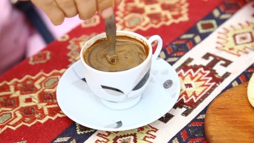 Close Up of Spoon Stirring Coffee in a Cup