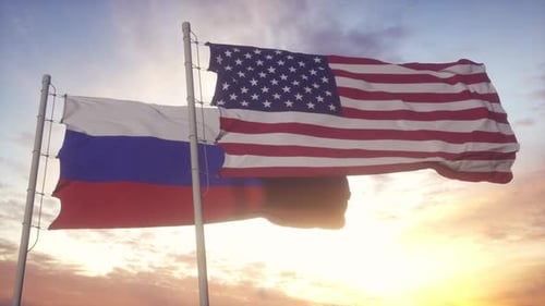 Waving Flags of the United States and Russia at Sunset