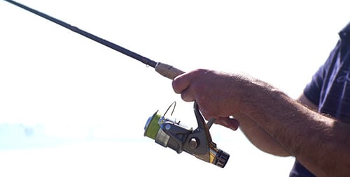 Fishing Rod Reel Being Used on a Sunny Day