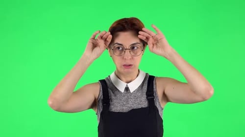 Woman Fanning Herself in Front of Green Screen