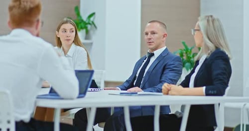 Business Partners are Talking in a Modern Office Discussing Plans and Strategies
