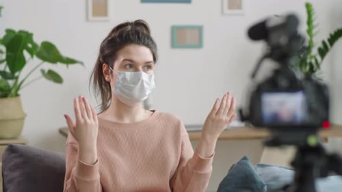 Woman with Mask Vlogging at Home