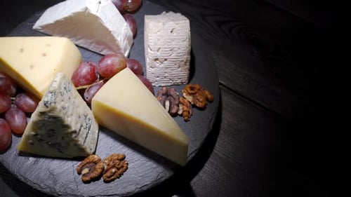 Cheese Assortment with Grapes and Walnuts on Platter