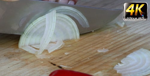 Slicing An Onion On A Cutting Board
