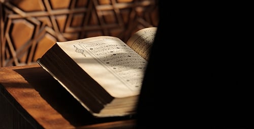 Quran Reading in Front of Geometric Carved Door