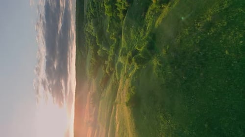 Golden Sunset over Rolling Green Hills Landscape