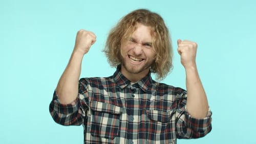 Excited Man Celebrates Success with Fists