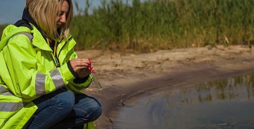 Woman Collects Water Sample for Scientific Testing