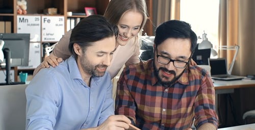 Team Working Together Using Tablet in Modern Office
