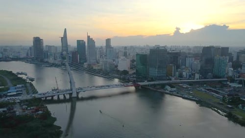 Flying at Sunset over Nearly Constructed Bridge on Saigon River in Downtown of Ho Chi Minh City Viet