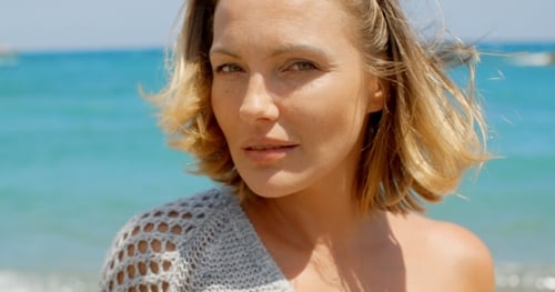 Close Up Of Blond Woman In Front Of Blue Ocean
