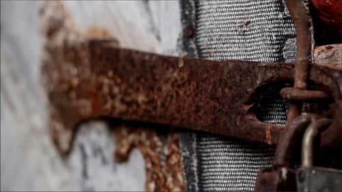 Rusty Hinge and Latch on Weathered Wooden Door