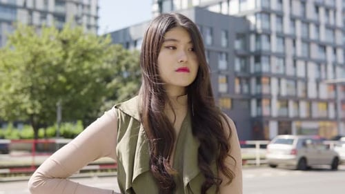 Young Asian Woman Thinks About Something As She Waits Street Urban Area