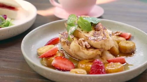 Appetizing French Toast with Caramelized Bananas and Strawberries