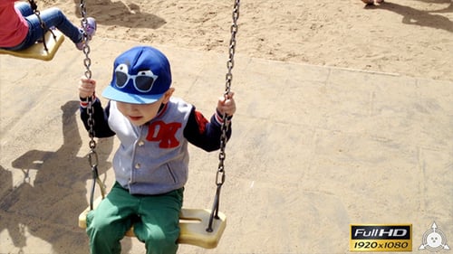 Delightful Child Swinging Happily on Playground