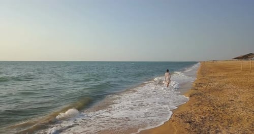 girl on the beach in a dress near the sea