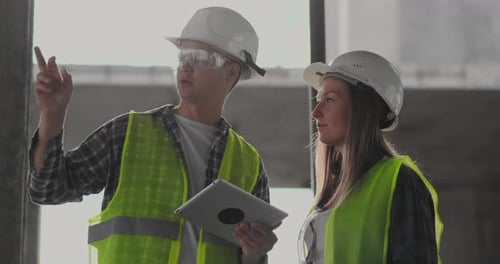 Portrait of Construction Engineers Working on Building Site