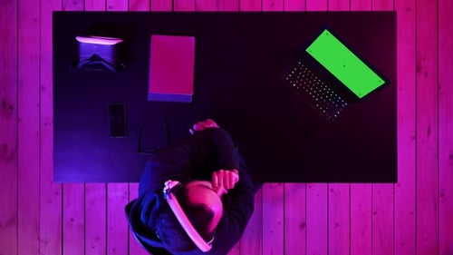 Gamer Wearing Headset Watching Stream of a Game
