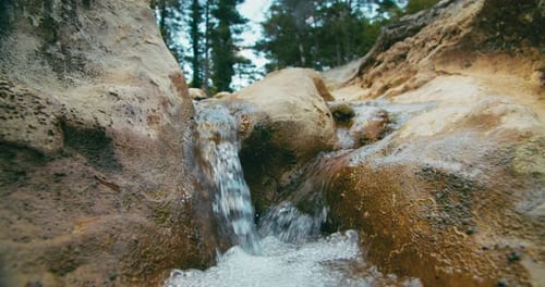Flowing Water on Rocks in Waterfall on Mountain River or Stream in the Forest