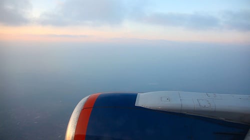 Airplane Wing in Flight at Sunrise