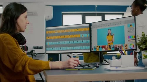 Woman Edits Photos on Dual Monitor Workstation