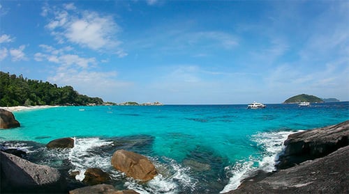 Tropical Beach with Turquoise Waters and Lush Greenery