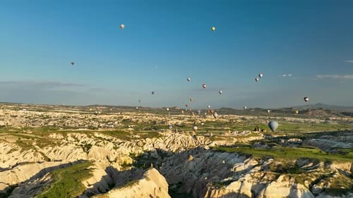 4K Aerial view of Goreme. Colorful hot air balloons fly over the valleys.