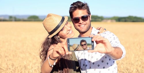 Smiling Couple Taking Selfie in a Wheat Field