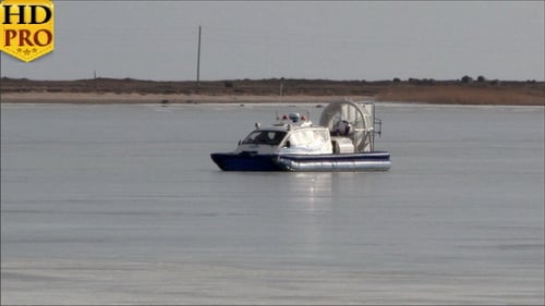 A Blue Boat on Snow Moving Fast