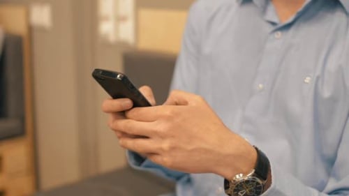 Adult Typing on Smartphone Indoors Close Up
