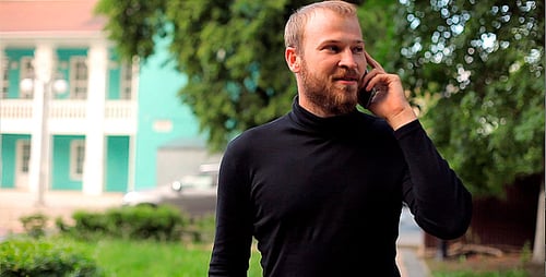 Man Walking and Talking on the Phone in the Park