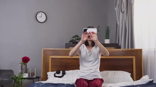 Woman Using Virtual Reality Headset in Bedroom