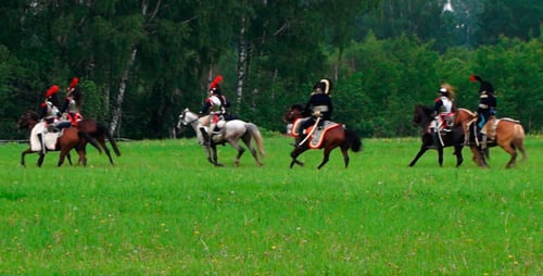 Men in Uniforms Riding Horses in Field