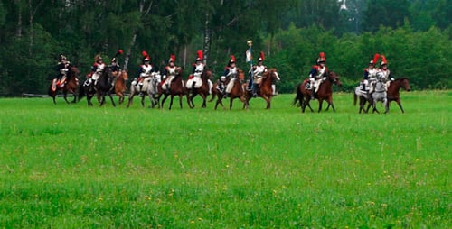 Adults Riding Horses Across Lush Green Field
