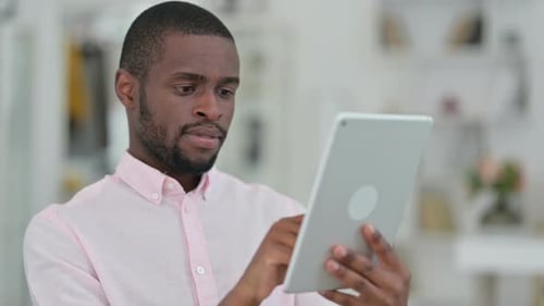Young Adult Using Tablet Device Indoors