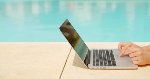 Working On Laptop In Swimming Pool Area