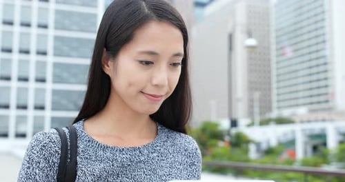 Woman use of tablet computer in city