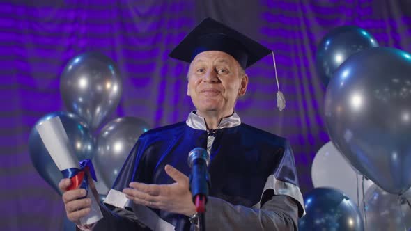 Male Rector in Academic Hat and Mantle Congratulates Students with ...
