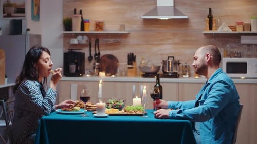 Couple Enjoying Romantic Candlelit Dinner Together