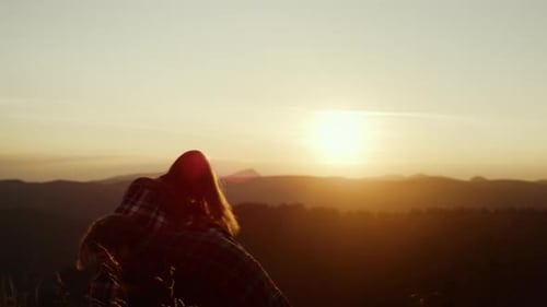 Couple Piggyback Ride At Sunset in Rural Setting