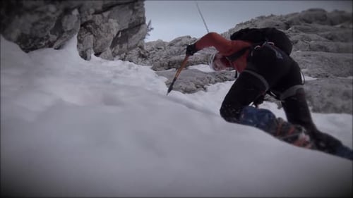 Climbers hike towards the top of a mountain.