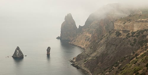 Misty Coastline with Cliffs and Sea Stacks