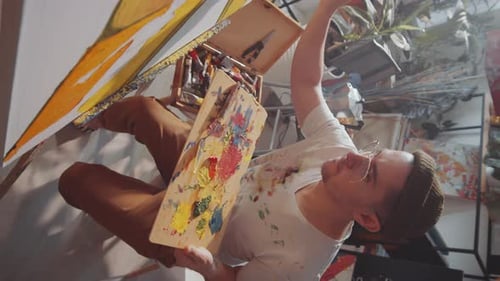 Young Man Painting in Art Studio