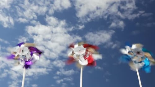 Colorful Pinwheels Spinning in a Blue Sky