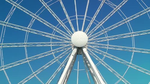 Giant White Ferris Wheel Against a Blue Sky