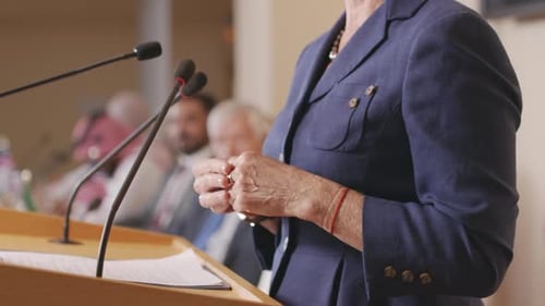 Woman Speaking at Podium at Corporate Event