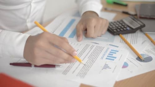 Man Analyzing a Business Report in an Office