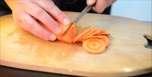 Slicing Carrot on Cutting Board in Close Up