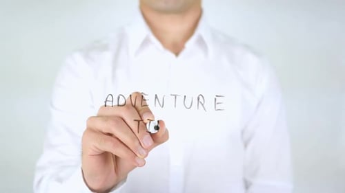 Person Writes 'Adventure Time' on Clear Surface